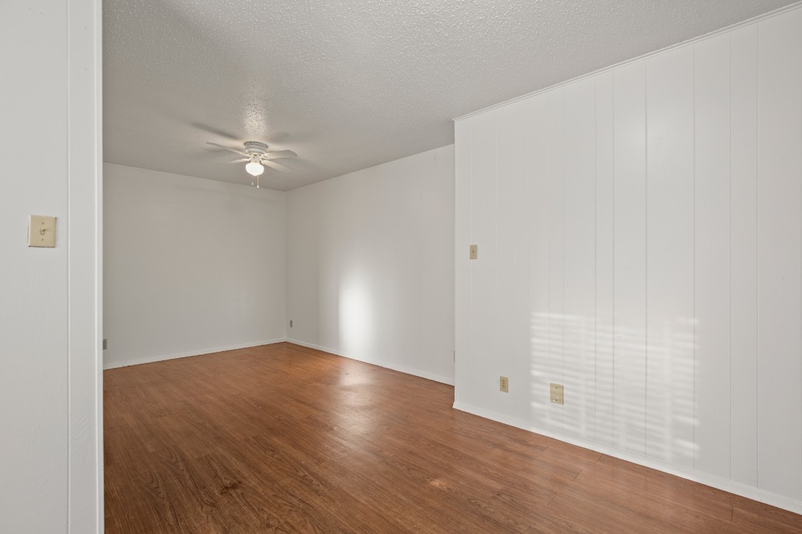 5300 Guadalupe Street, Unit 108 Austin, TX 78751 - Photo 6 of 11 an empty room with wooden floor and fan
