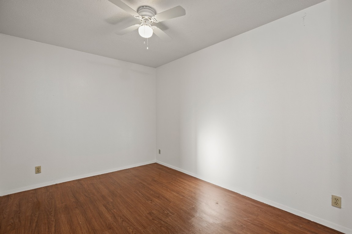 5300 Guadalupe Street, Unit 108 Austin, TX 78751 - Photo 7 of 11 an empty room with wooden floor and fan