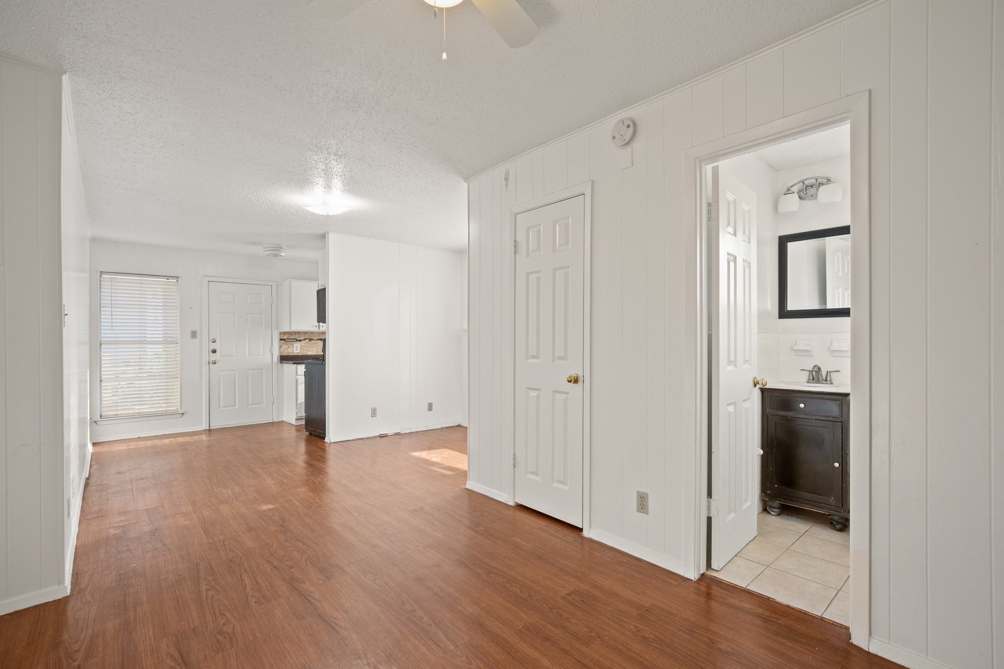 5300 Guadalupe Street, Unit 108 Austin, TX 78751 - Photo 10 of 11 a view of an empty room with wooden floor and a bathroom