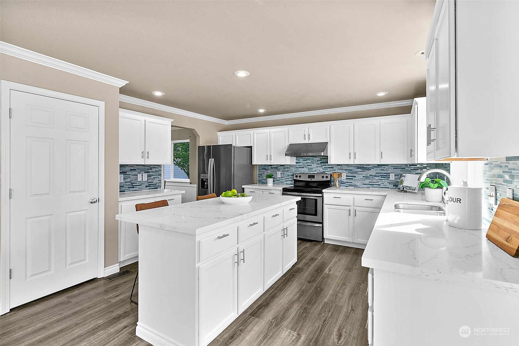 6723 Southeast 4th Street Renton, WA 98059 - Photo 13 of 38 a kitchen with white cabinets and stainless steel appliances
