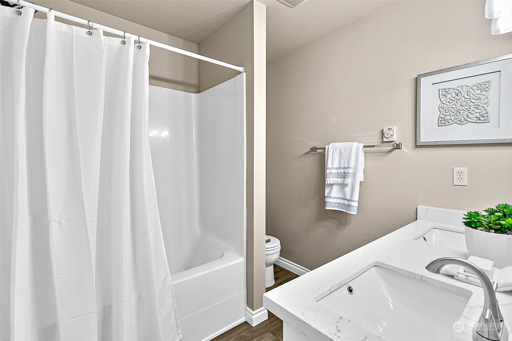 6723 Southeast 4th Street Renton, WA 98059 - Photo 17 of 38 a bathroom with a sink a mirror and a shower curtain