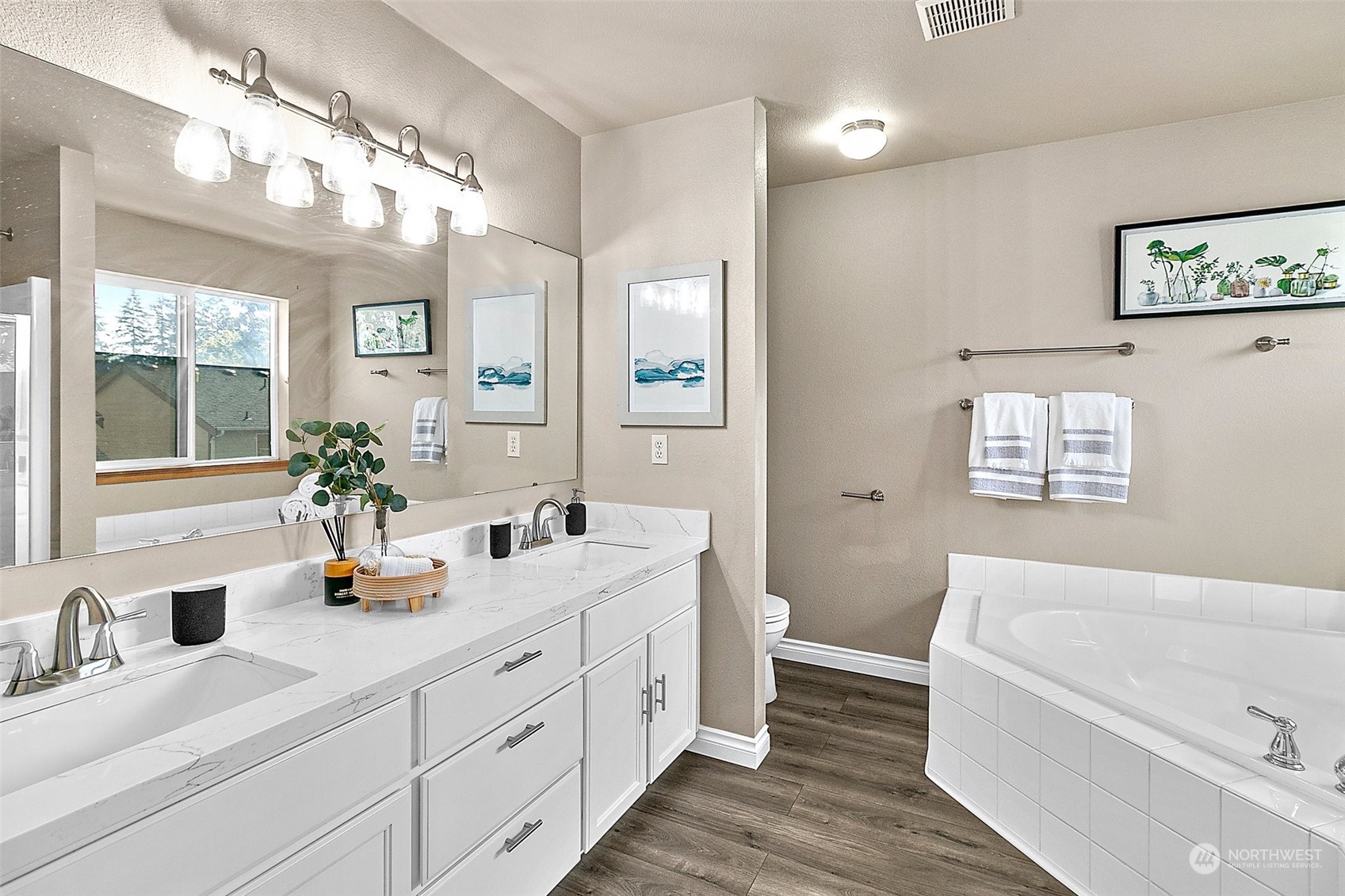 6723 Southeast 4th Street Renton, WA 98059 - Photo 28 of 38 a bathroom with a double vanity sink a large mirror a toilet and a bathtub