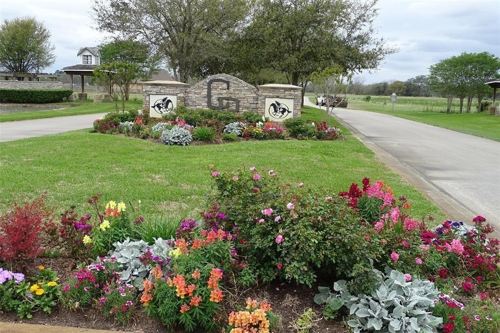 702 County Road 34 Angleton, TX 77515 - Photo 3 of 10 a view of a garden with flowers and trees