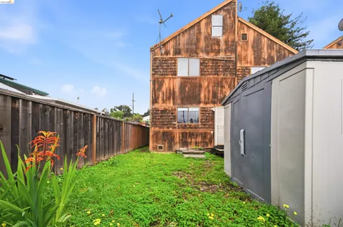 a backyard view with small garden and entertaining space