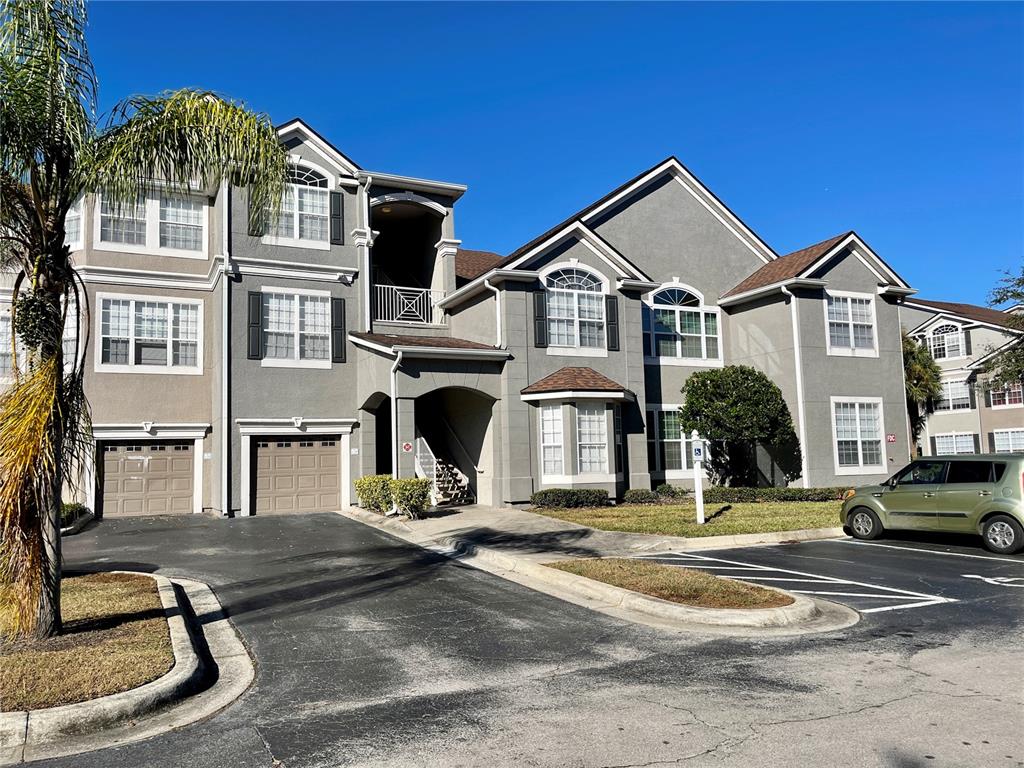 a view of a house with cars park in front of it