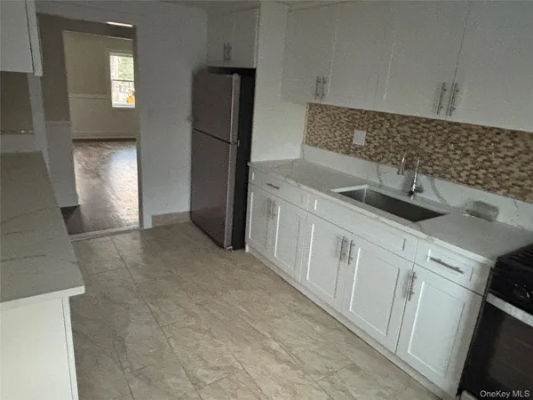 a kitchen with a sink and refrigerator