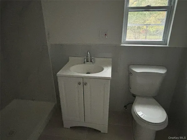 a bathroom with a toilet sink and window