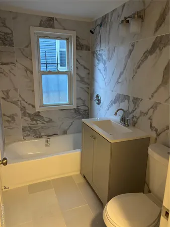 a bathroom with a sink a toilet and bathtub