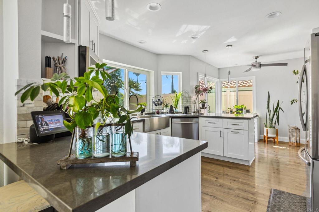 1896 Timber Trail Vista, CA 92081 - Photo 12 of 65 a kitchen with stainless steel appliances kitchen island granite countertop a stove a sink and a counter space