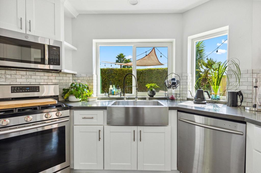 1896 Timber Trail Vista, CA 92081 - Photo 14 of 65 a kitchen with appliances a sink and a counter space