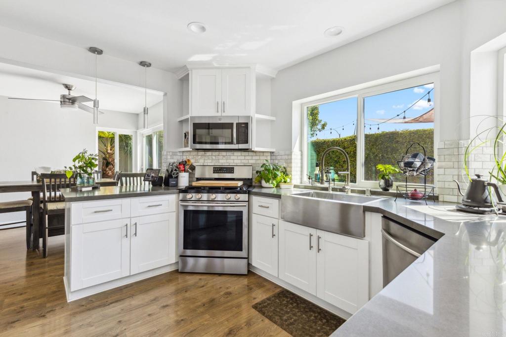 1896 Timber Trail Vista, CA 92081 - Photo 15 of 65 a kitchen with stainless steel appliances granite countertop a stove a sink and a microwave