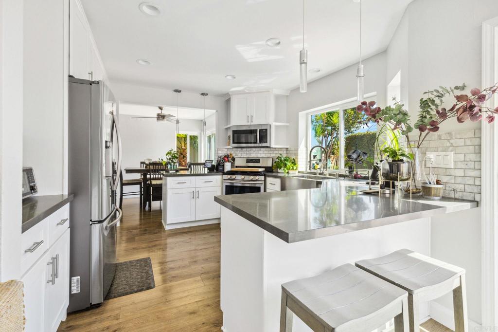 1896 Timber Trail Vista, CA 92081 - Photo 16 of 65 a kitchen with stainless steel appliances granite countertop a sink a stove and a refrigerator