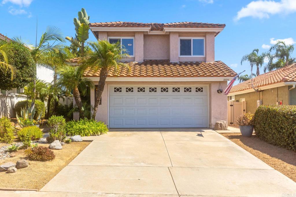 1896 Timber Trail Vista, CA 92081 - Photo 28 of 65 a front view of a house with a yard and potted plants