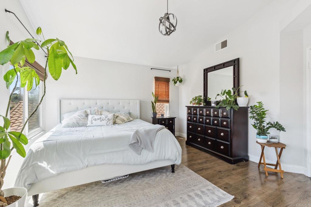1896 Timber Trail Vista, CA 92081 - Photo 39 of 65 a bedroom with a bed dresser and a potted plant
