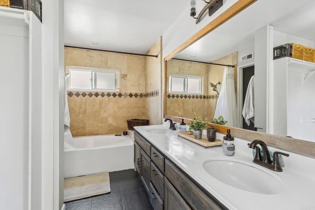 1896 Timber Trail Vista, CA 92081 - Photo 40 of 65 a bathroom with a tub sink and mirror