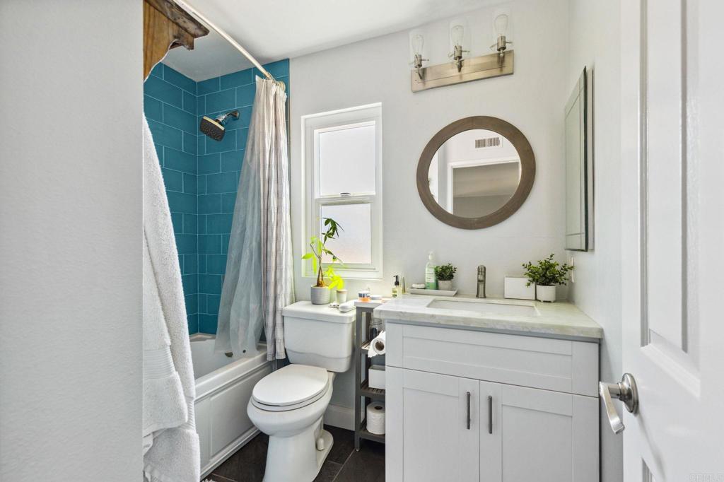 1896 Timber Trail Vista, CA 92081 - Photo 49 of 65 a bathroom with a sink a toilet and a mirror
