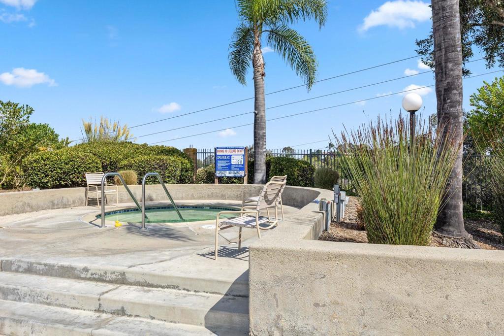 1896 Timber Trail Vista, CA 92081 - Photo 58 of 65 a view of a terrace with couches and red umbrella