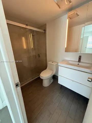 a bathroom with a toilet sink and a mirror