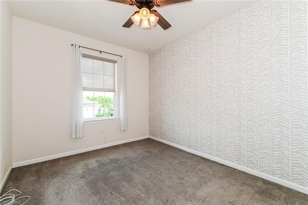4721 Arboretum Circle, Unit 201 Naples, FL 34112 - Photo 13 of 26 an empty room with a window