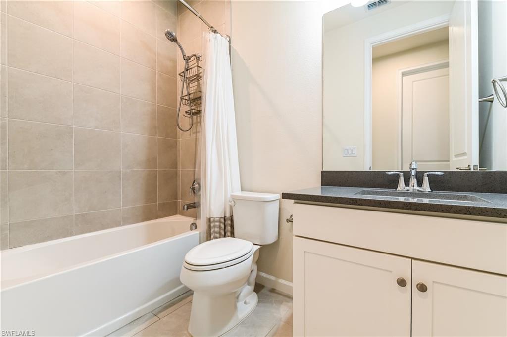 4721 Arboretum Circle, Unit 201 Naples, FL 34112 - Photo 14 of 26 a bathroom with a sink a toilet and a bathtub