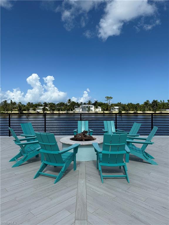 4721 Arboretum Circle, Unit 201 Naples, FL 34112 - Photo 20 of 26 a view of a lake with couches chairs