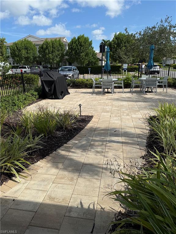 4721 Arboretum Circle, Unit 201 Naples, FL 34112 - Photo 23 of 26 a view of a swimming pool with a patio