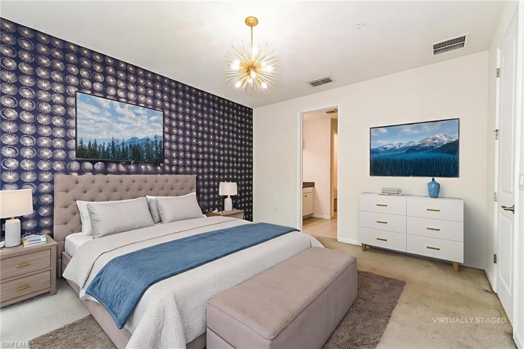 4721 Arboretum Circle, Unit 201 Naples, FL 34112 - Photo 3 of 26 a bedroom with a bed and a flat screen tv
