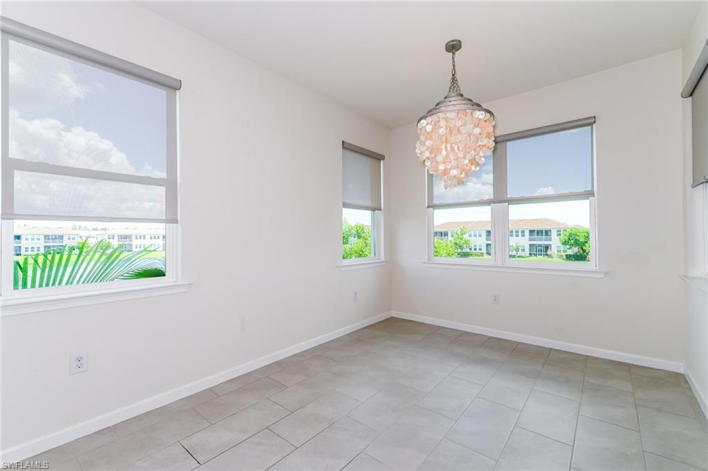 4721 Arboretum Circle, Unit 201 Naples, FL 34112 - Photo 4 of 26 a view of entryway with window and chandelier