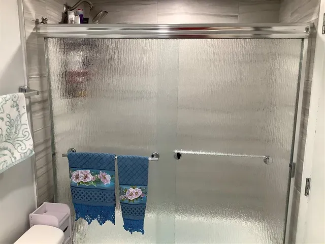 a bathroom with a shower and a sink