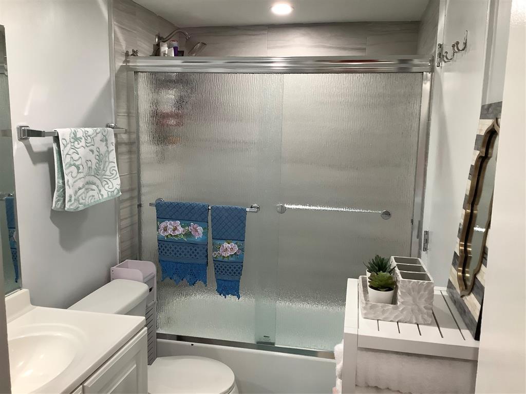 4174 Inverrary Drive, Unit 309 Lauderhill, FL 33319 - Photo 12 of 21 a bathroom with a sink a toilet and shower