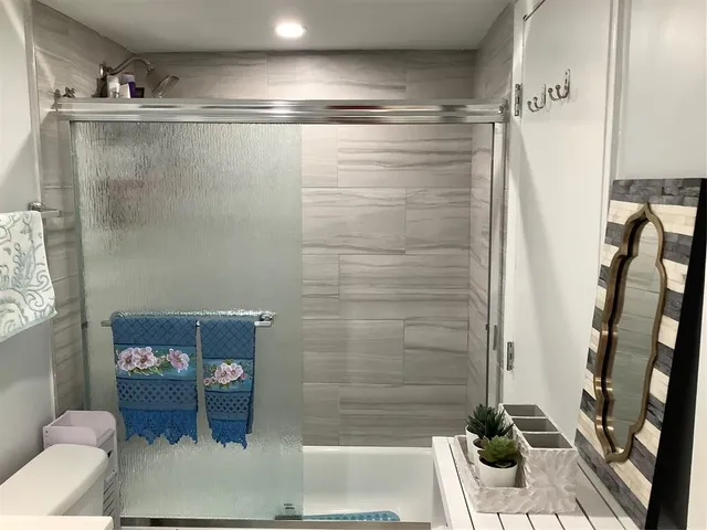 a bathroom with a shower and a sink
