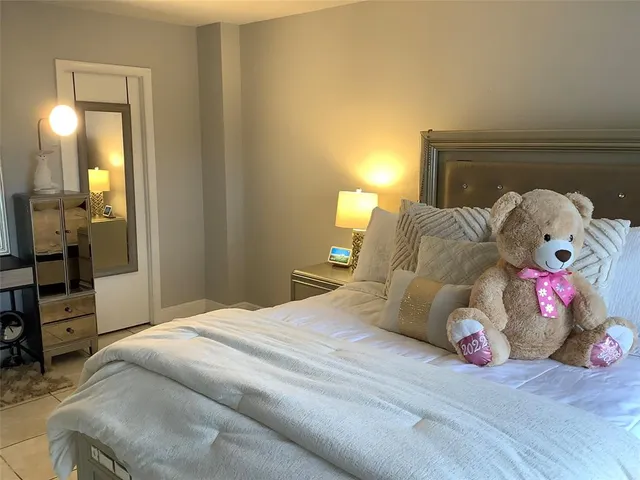 a bedroom with a bed and a mirror