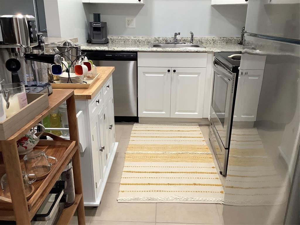 4174 Inverrary Drive, Unit 309 Lauderhill, FL 33319 - Photo 4 of 21 a utility room with sink dryer and washer