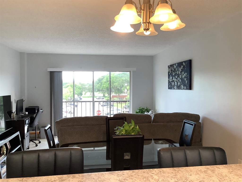 4174 Inverrary Drive, Unit 309 Lauderhill, FL 33319 - Photo 10 of 21 a view of a dining room with furniture and chandelier