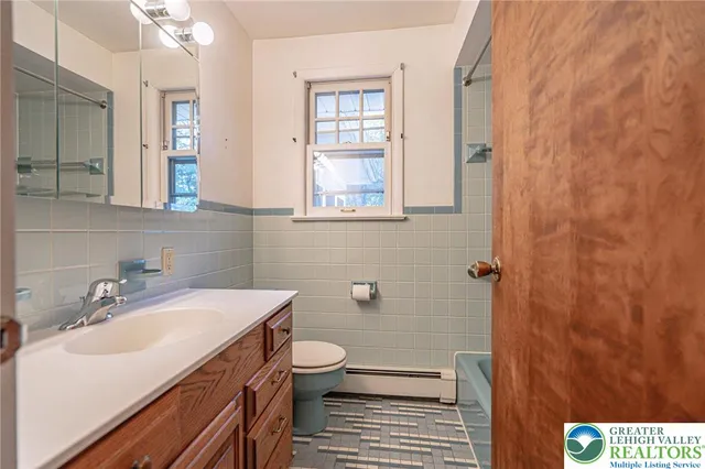 a bathroom with a sink a mirror and a shower