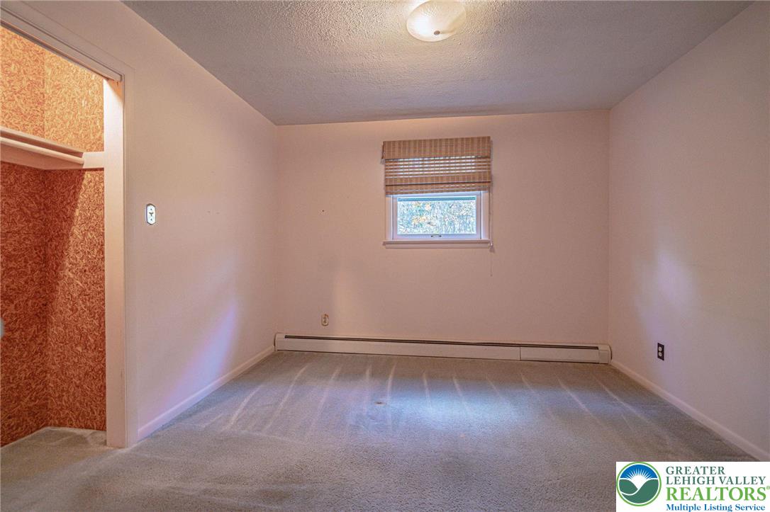 258 Kohlers Hill Road Kutztown, PA 19530 - Photo 31 of 60 an empty room with wooden floor and windows