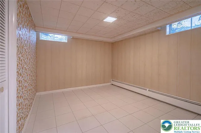 a room with water heater and a wooden cabinets