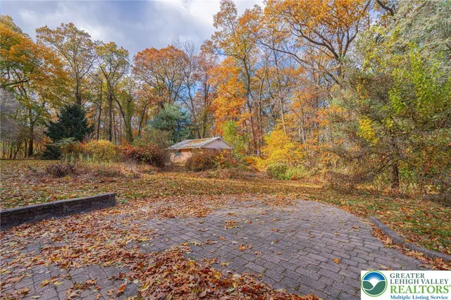 a view of a yard with wooden fence