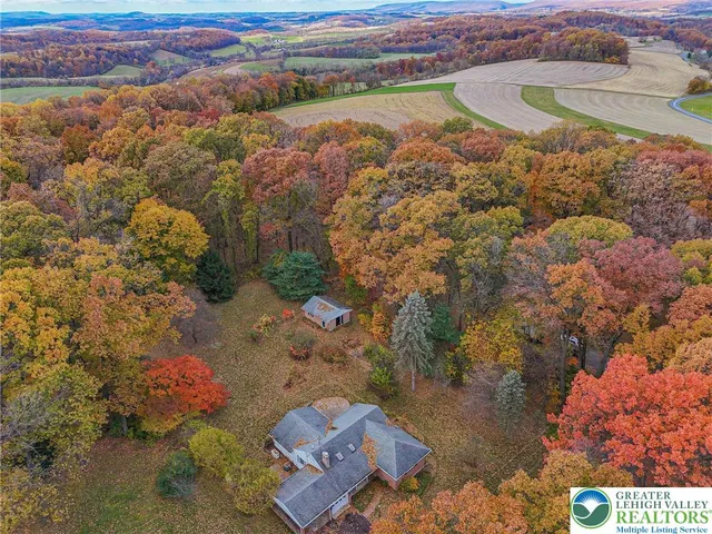 a view of a hallway with wooden floor and windows