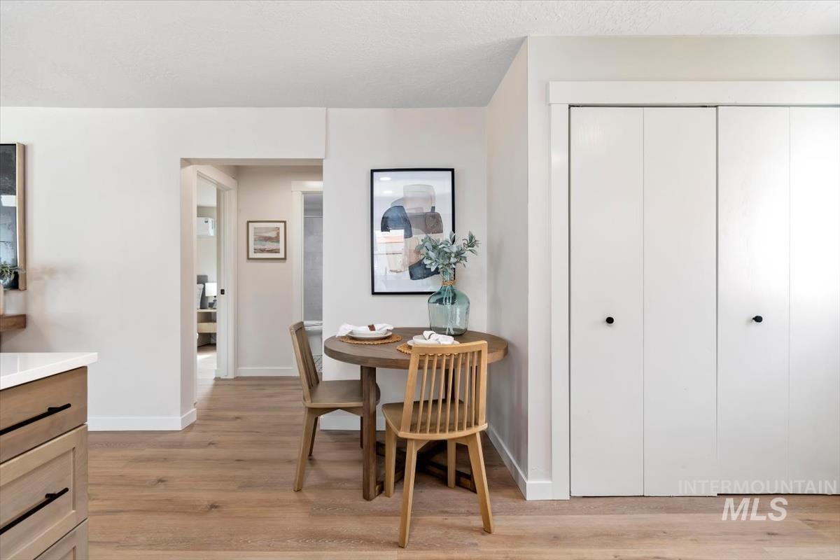 3005 West Hester Street Boise, ID 83702 - Photo 14 of 32 Dining area featuring light wood-finish flooring, white walls, and a bi-fold closet with matte black hardware