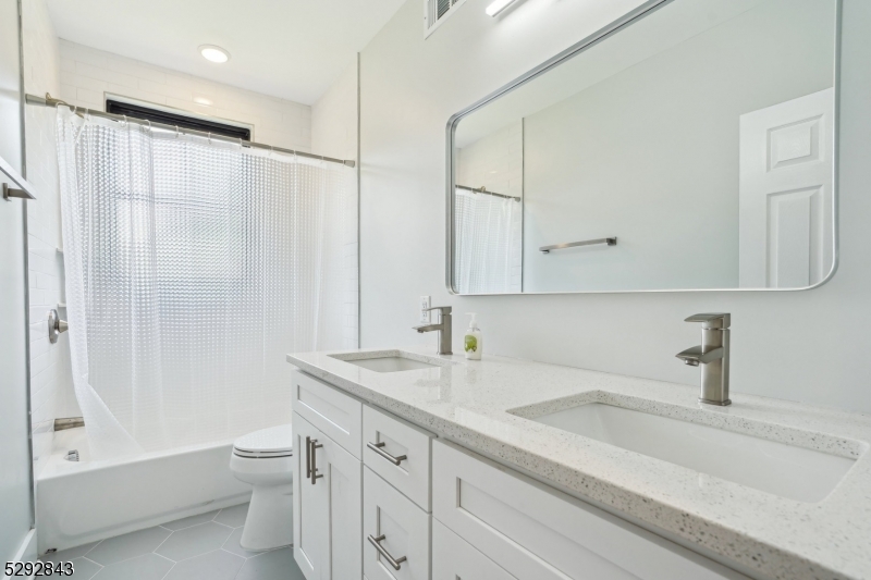 29 Arlington Road, Unit 1 Cranford, NJ 07016 - Photo 11 of 15 a bathroom with a sink a toilet and shower