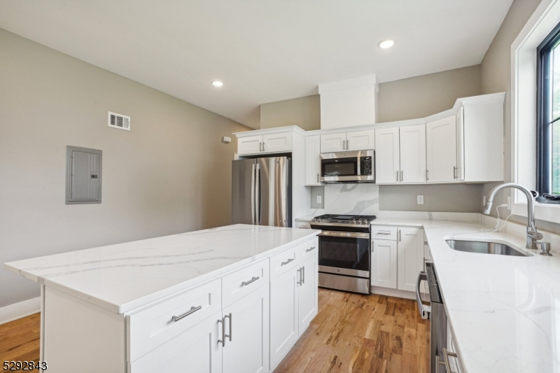 29 Arlington Road, Unit 1 Cranford, NJ 07016 - Photo 5 of 15 a kitchen with granite countertop white cabinets and stainless steel appliances