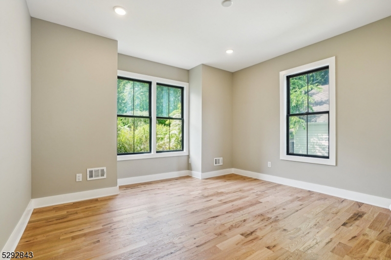 29 Arlington Road, Unit 1 Cranford, NJ 07016 - Photo 10 of 15 a view of an empty room with wooden floor and a window