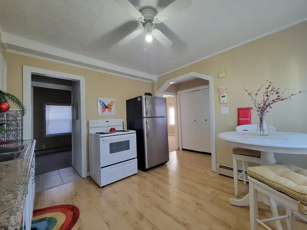 a kitchen with a refrigerator and a stove