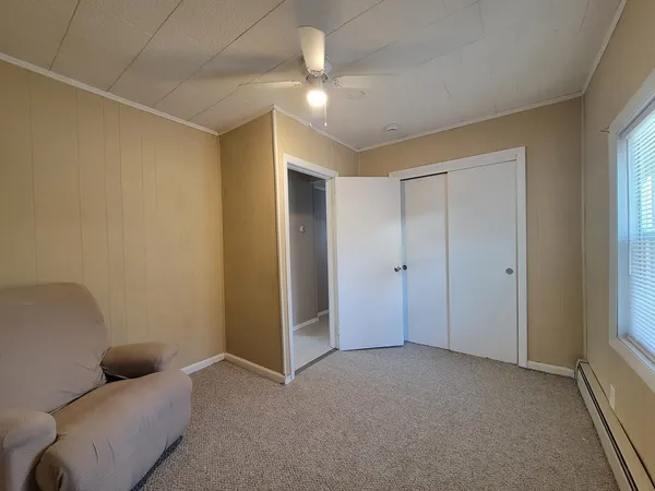 a living room with furniture and a ceiling fan