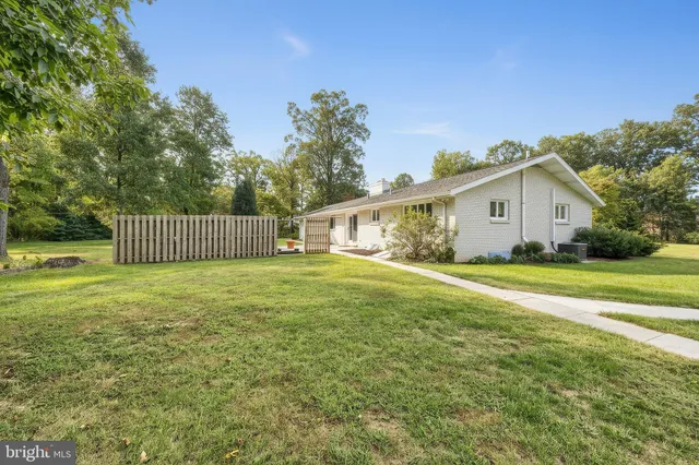 a view of outdoor space with green field and trees
