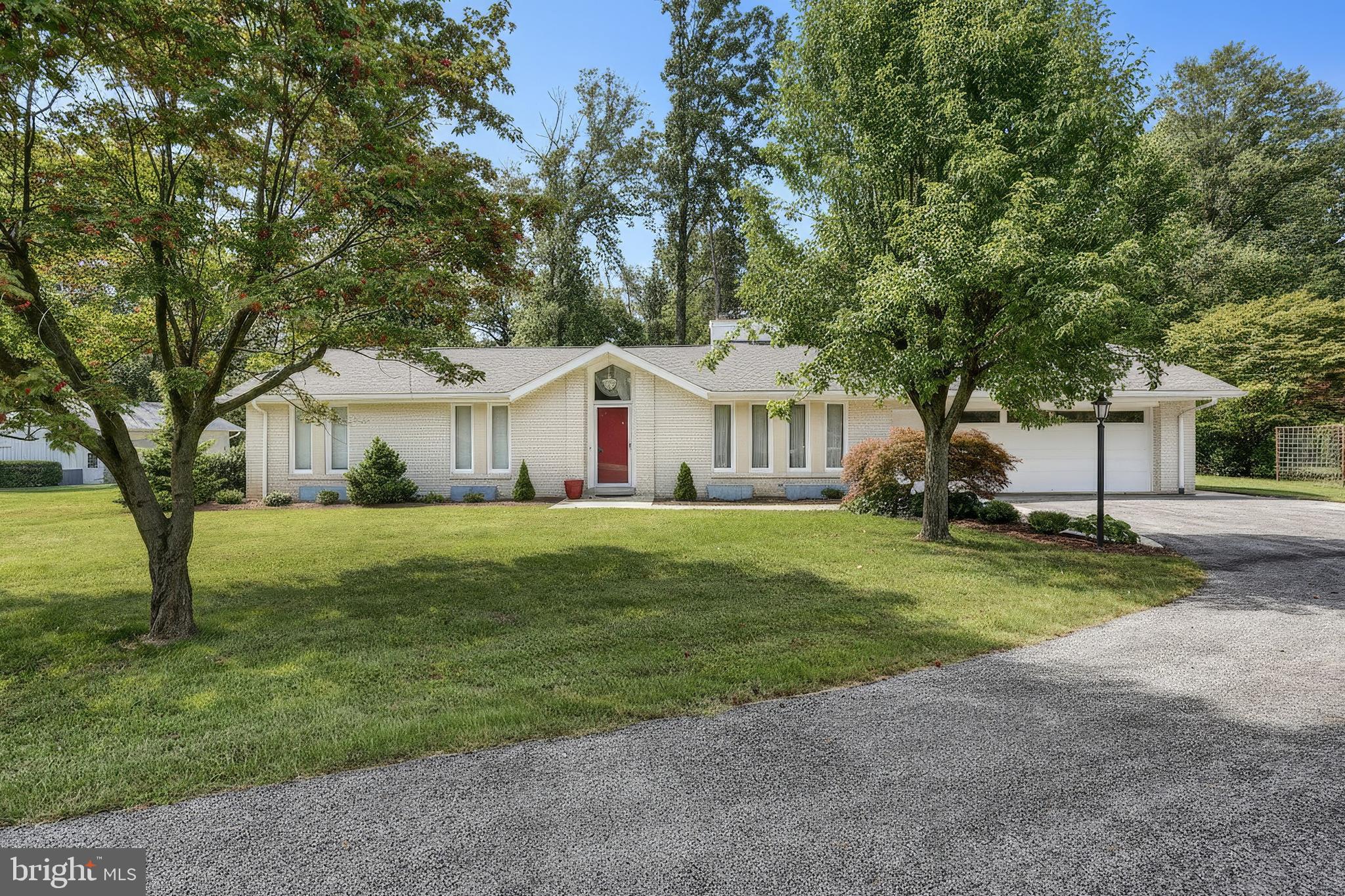 1063 Porters Road Spring Grove, PA 17362 - Photo 2 of 56 a view of a white house in front of a big yard with large trees