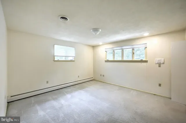 a bathroom with a double vanity sink mirror and shower
