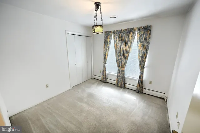 a view of an empty room with a fireplace