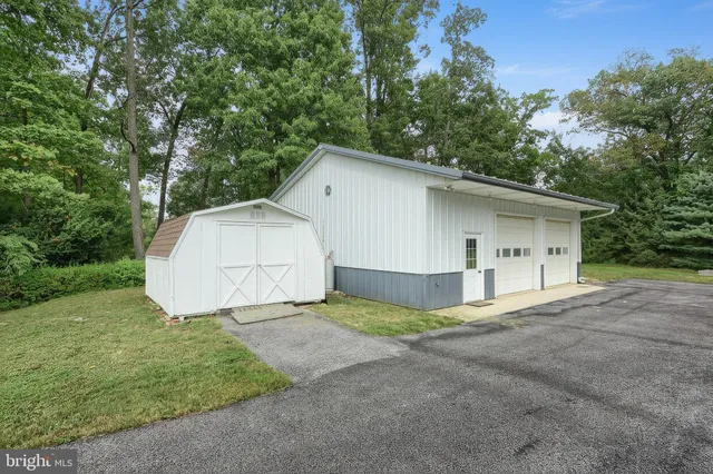 a view of a house with a yard and garage